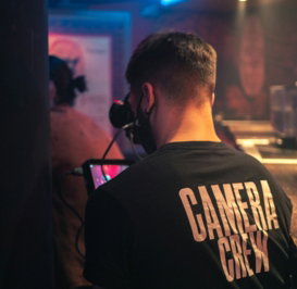 man in black and white crew neck t-shirt standing near man in black t-shirt